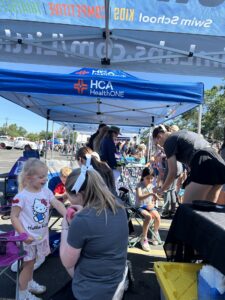 Children at SwimLabs tent at Littleton Fire Muster event