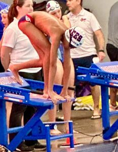 Success story: Zion diving into the water at a swimming competition